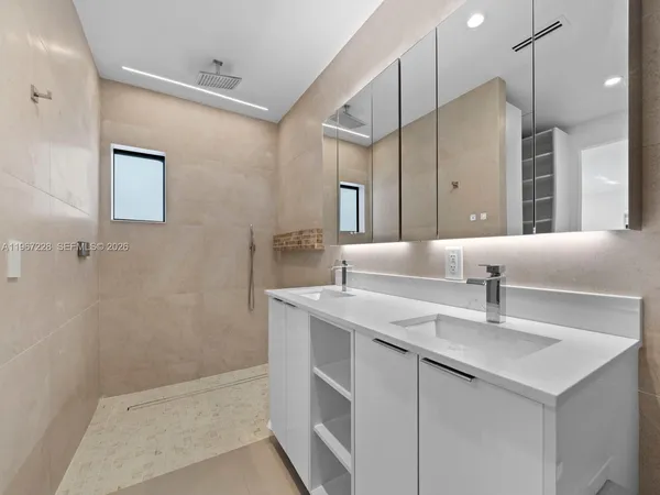 a kitchen with a sink and a mirror