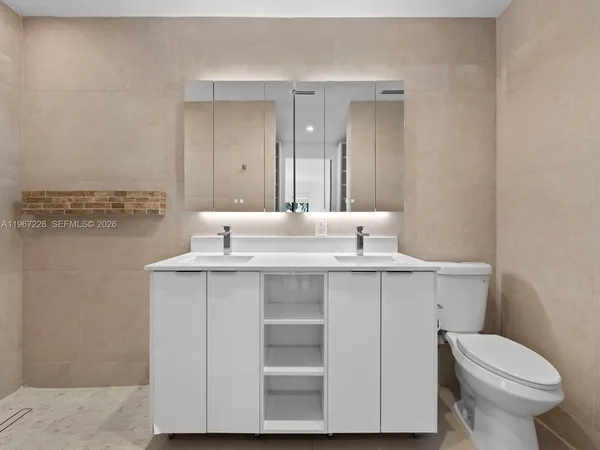 a bathroom with a sink toilet and vanity