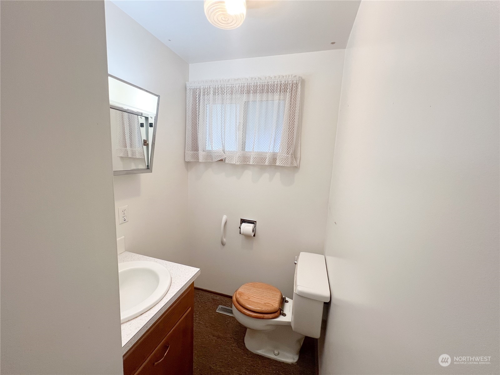 116 Silver Drive Electric City, WA 99123 - Photo 15 of 27 a white toilet sitting next to a bathroom sink