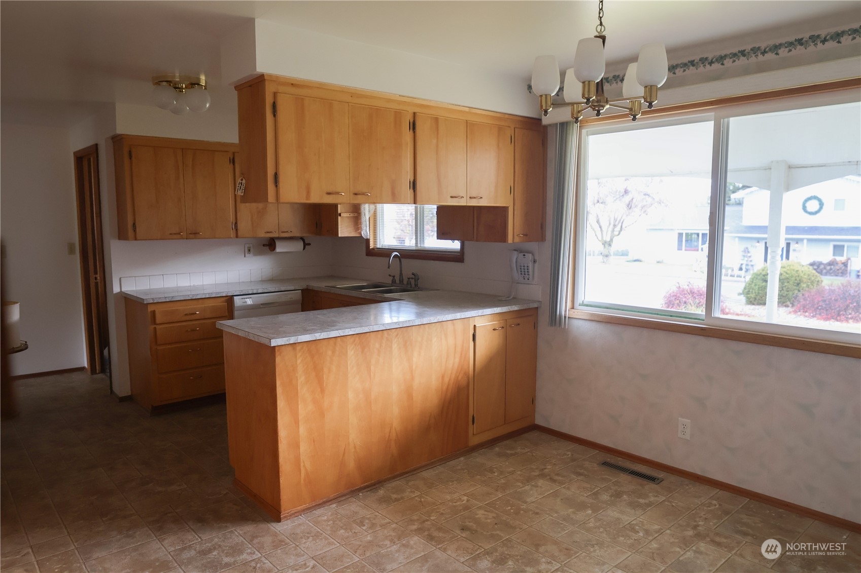 116 Silver Drive Electric City, WA 99123 - Photo 8 of 27 a kitchen with kitchen island granite countertop a sink appliances cabinets and a counter top space