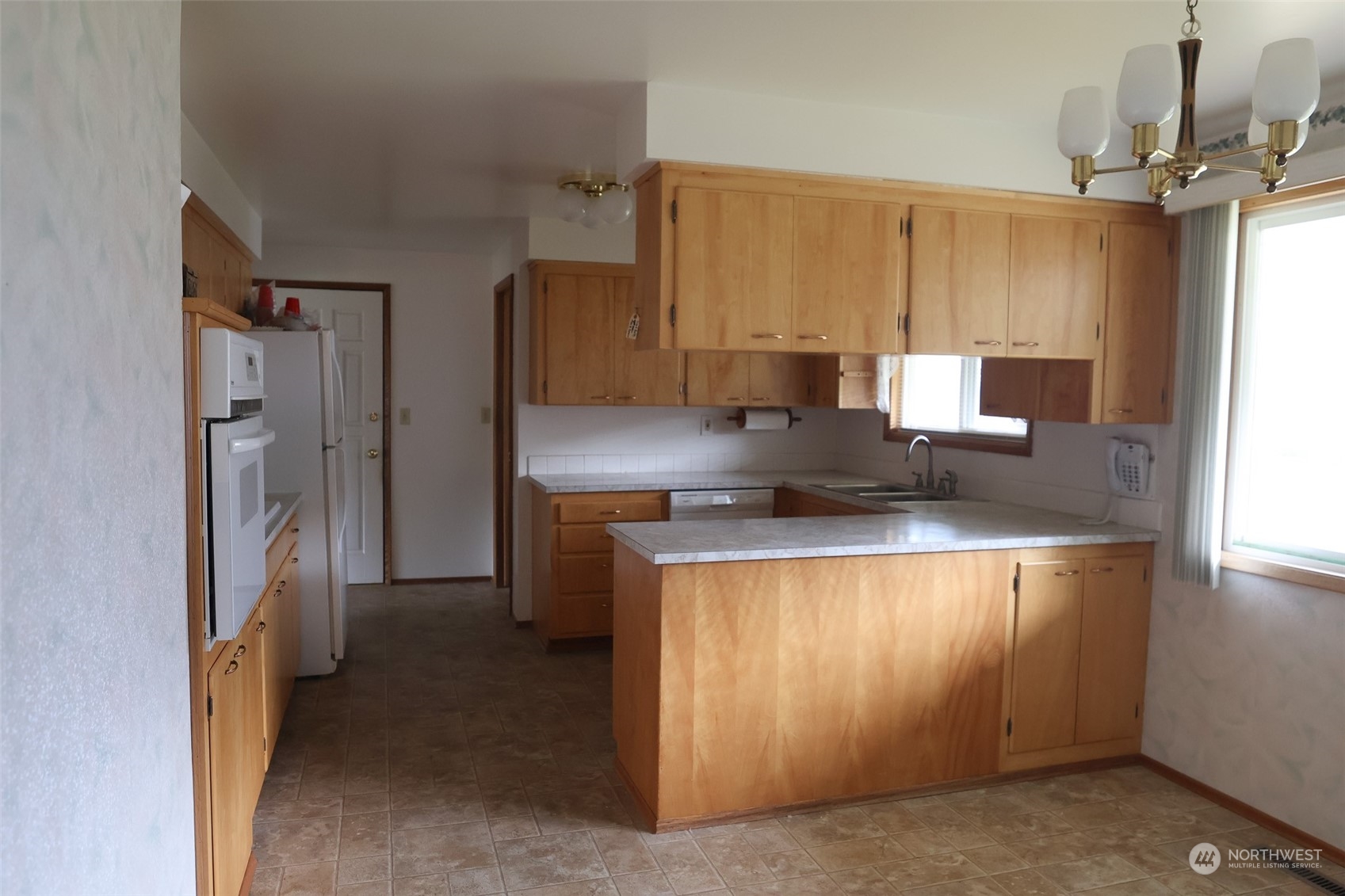 116 Silver Drive Electric City, WA 99123 - Photo 10 of 27 a kitchen with stainless steel appliances a refrigerator and a stove