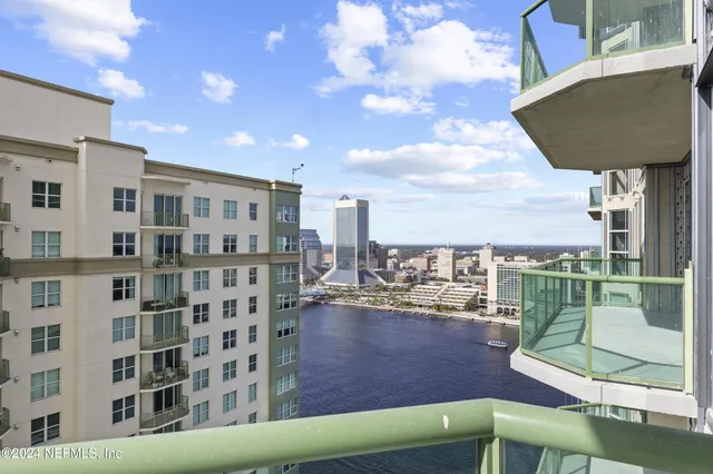 a spacious bedroom with a bed and cabinets