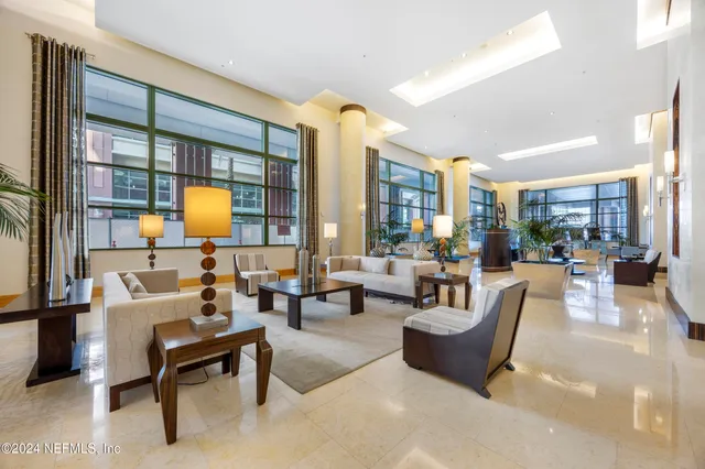 a living room with furniture and a potted plant