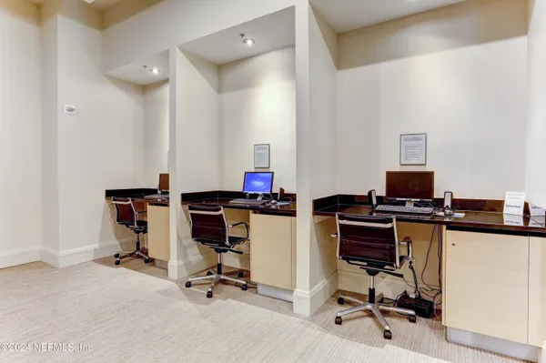a kitchen with stainless steel appliances kitchen island granite countertop a stove a refrigerator a sink a dining table and chairs with wooden floor