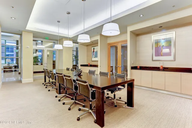 a living room with furniture a flat screen tv and a window