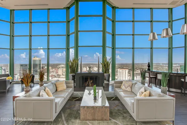 a patio with a table and chairs and potted plants