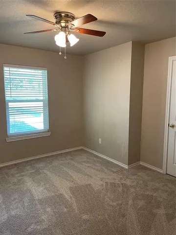 a view of an empty room and a window