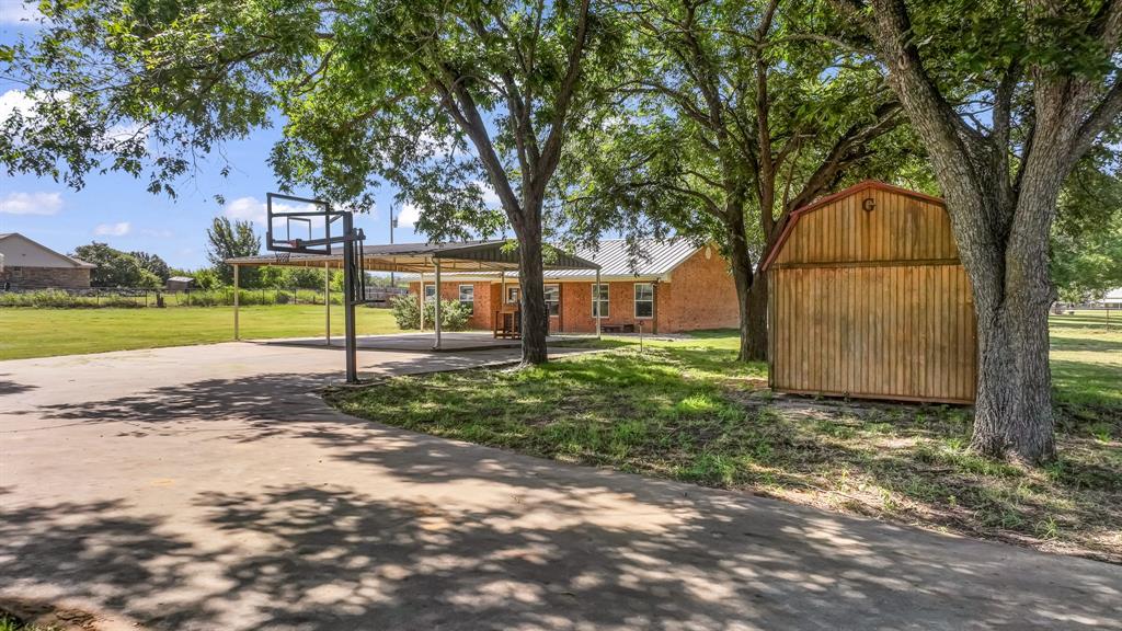 111 Quail Drive Springtown, TX 76082 - Photo 16 of 22 a view of a yard with a tree
