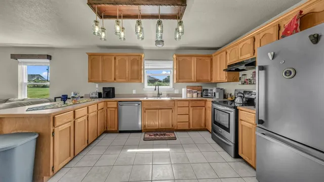 a kitchen with a cabinets window and stainless steel appliances