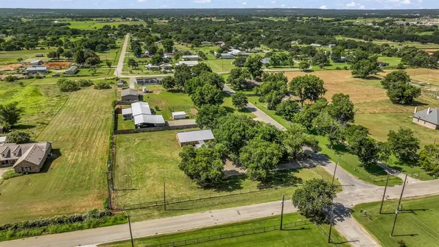 an aerial view of a residential houses with outdoor space and garden