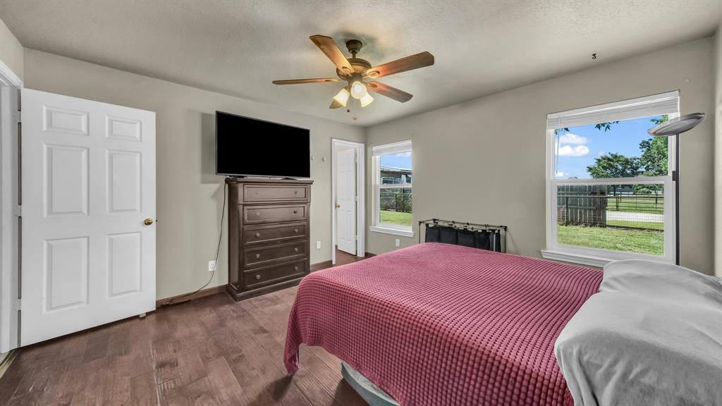 111 Quail Drive Springtown, TX 76082 - Photo 6 of 22 a bedroom with a bed and a flat screen tv