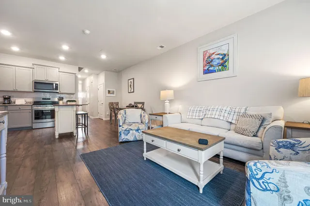 a living room with furniture and kitchen view