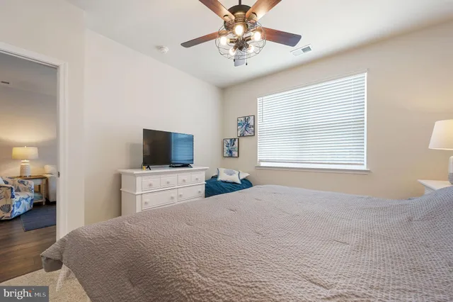 a bedroom with a large bed and a tv