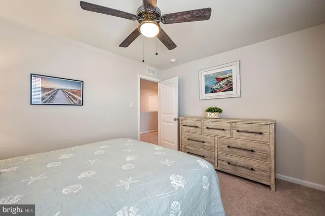 a bedroom with a bed dresser and a window