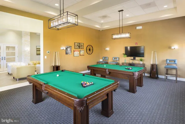 a room with pool table and windows