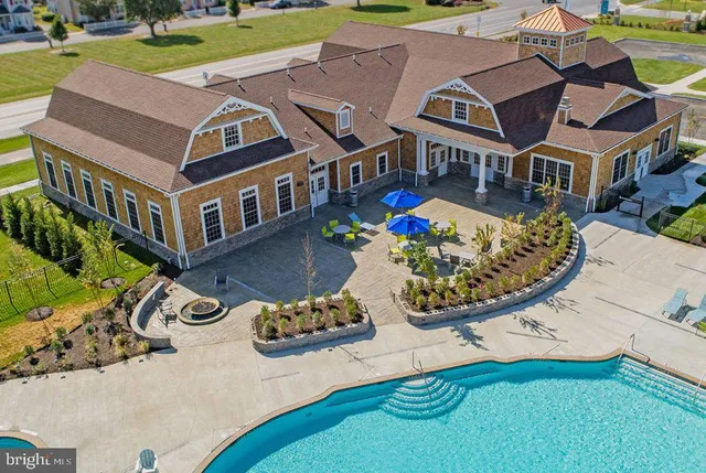 an aerial view of a house with swimming pool patio and outdoor seating