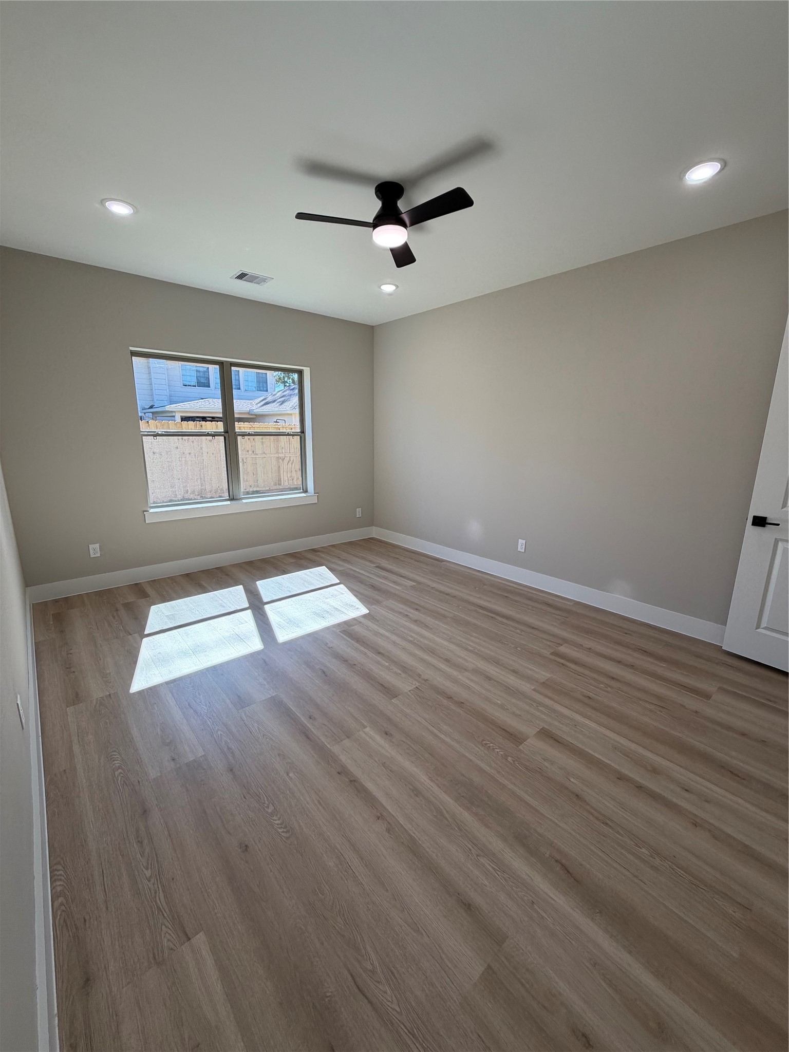 2523 Liguria Spring Spring, TX 77388 - Photo 14 of 26 an empty room with wooden floor and windows