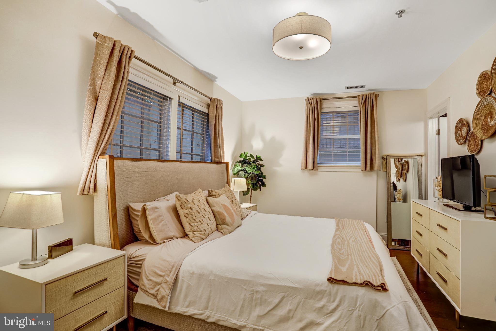 3937 Davis Place Northwest, Unit 1 Washington, DC 20007 - Photo 13 of 22 a bedroom with a bed and a flat tv screen on dresser