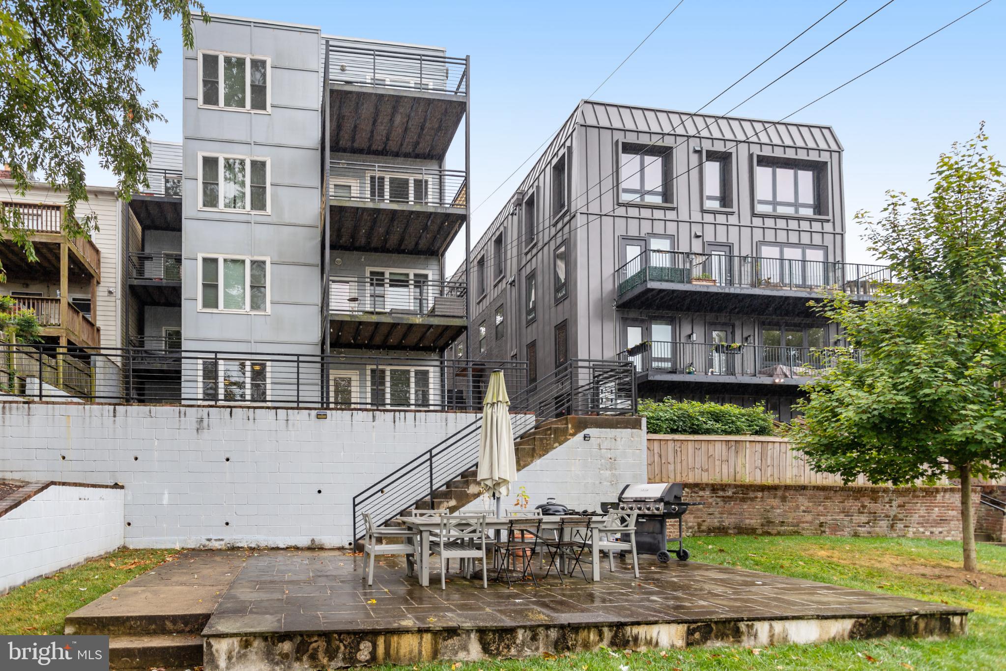 3937 Davis Place Northwest, Unit 1 Washington, DC 20007 - Photo 21 of 22 a view of a brick building with many windows and plants