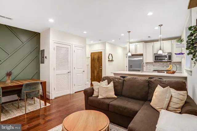 a living room with furniture and kitchen view