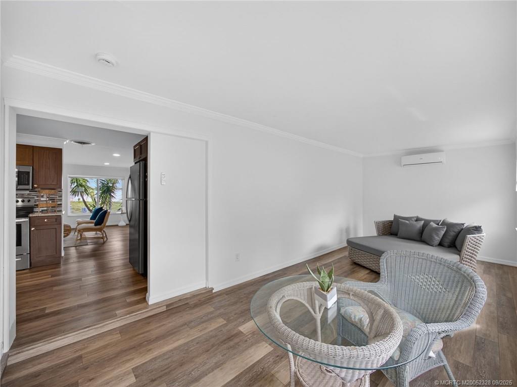 2346 Northeast Rustic Place Jensen Beach, FL 34957 - Photo 11 of 18 a dining room with furniture and wooden floor