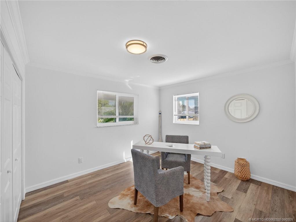 2346 Northeast Rustic Place Jensen Beach, FL 34957 - Photo 14 of 18 a view of a dining room with furniture and wooden floor