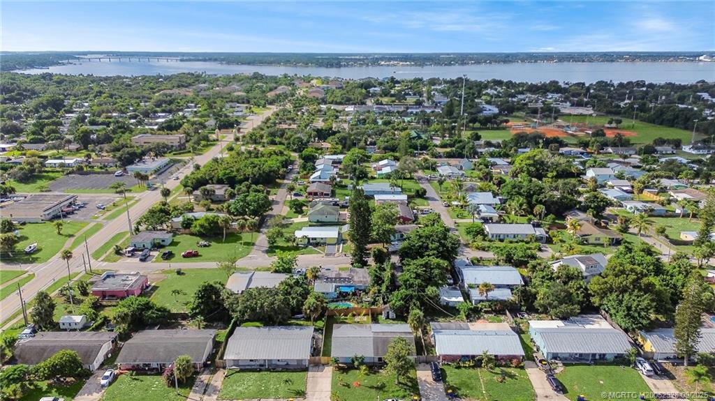2346 Northeast Rustic Place Jensen Beach, FL 34957 - Photo 18 of 18 an aerial view of a city with lots of residential buildings