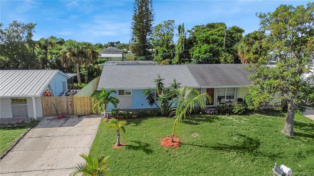 2346 Northeast Rustic Place Jensen Beach, FL 34957 - Photo 2 of 18 a view of a house with garden