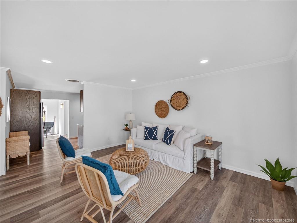 2346 Northeast Rustic Place Jensen Beach, FL 34957 - Photo 4 of 18 a living room with furniture and a chair