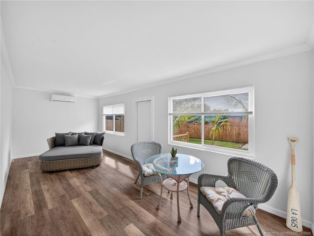 2346 Northeast Rustic Place Jensen Beach, FL 34957 - Photo 9 of 18 a living room with furniture and a wooden floor