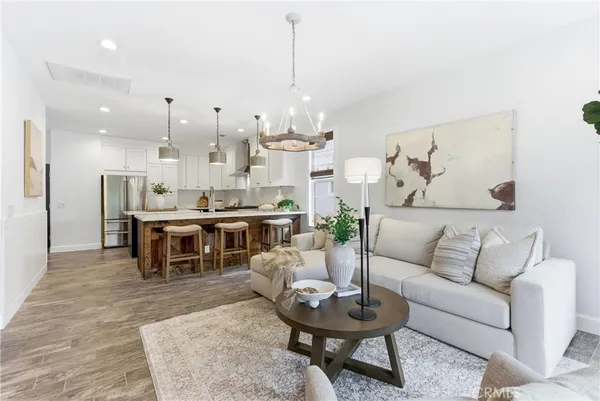 a kitchen with stainless steel appliances granite countertop a sink a stove a refrigerator a microwave a counter space and cabinets
