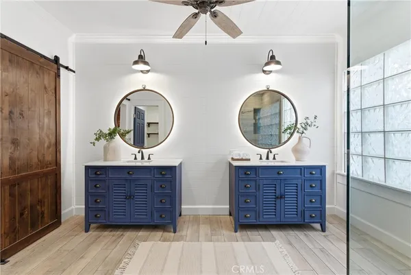 a bathroom with a double vanity sink and a mirror