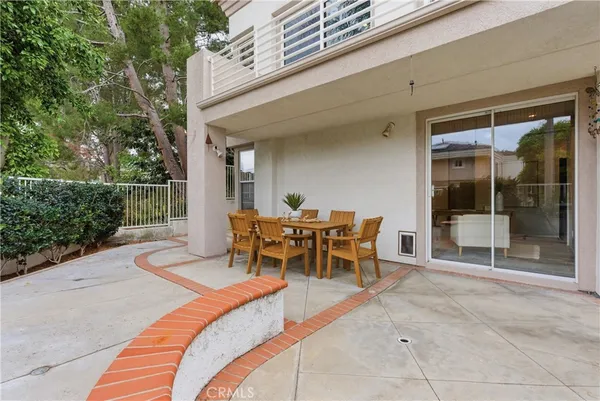a view of a patio with couches and potted plants