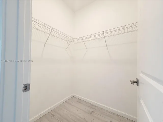 a bathroom with a double vanity sink toilet mirror and shower