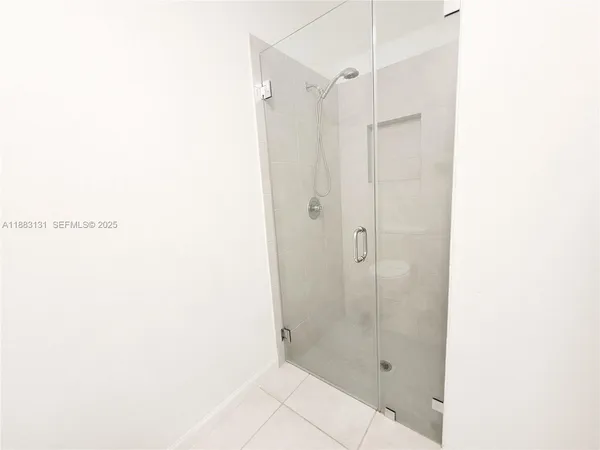 a bathroom with a glass shower door