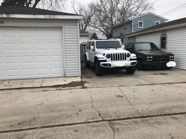 a view of a car parked in back of a house