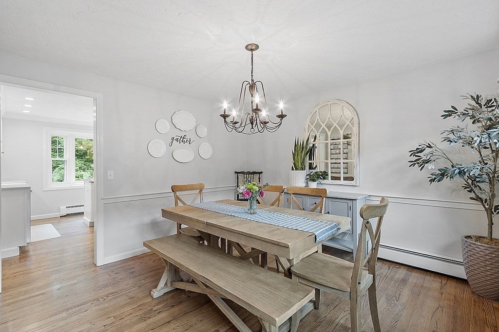 27 Tanglewood Road Sterling, MA 01564 - Photo 17 of 38 a view of a dining room with furniture a chandelier and wooden floor