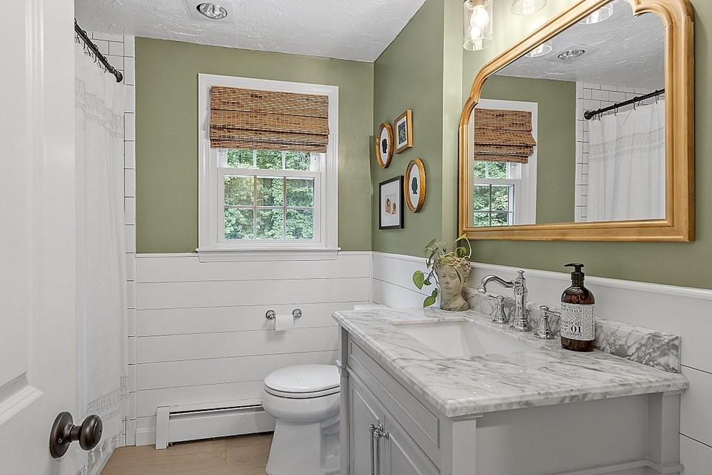 27 Tanglewood Road Sterling, MA 01564 - Photo 21 of 38 a bathroom with a granite countertop toilet a sink and a mirror