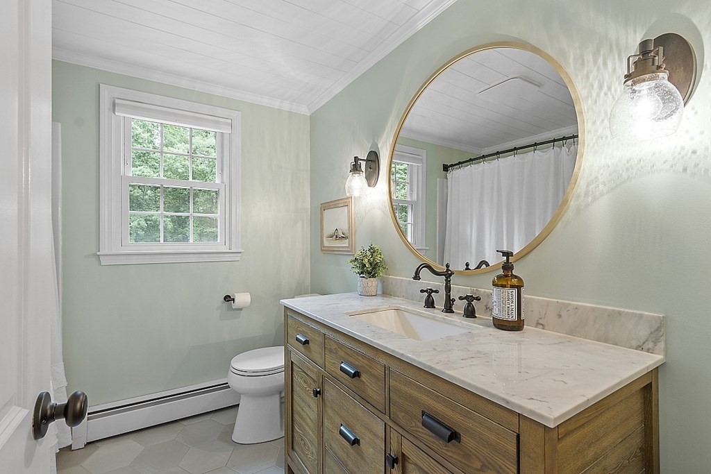 27 Tanglewood Road Sterling, MA 01564 - Photo 28 of 38 a bathroom with a granite countertop toilet a sink and a mirror