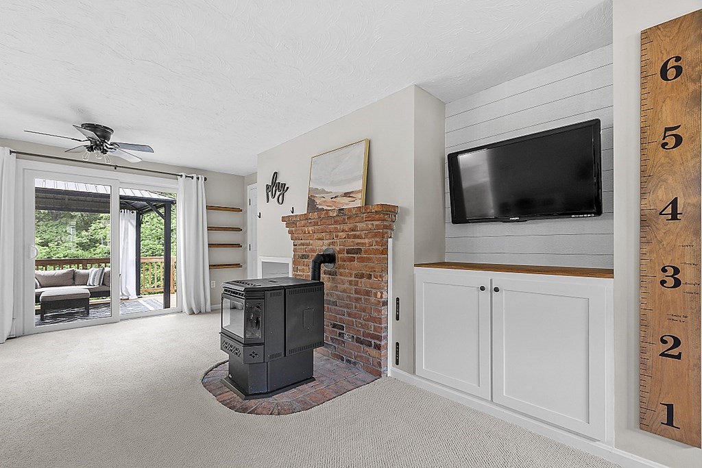 27 Tanglewood Road Sterling, MA 01564 - Photo 5 of 38 a living room with fireplace furniture and a flat screen tv
