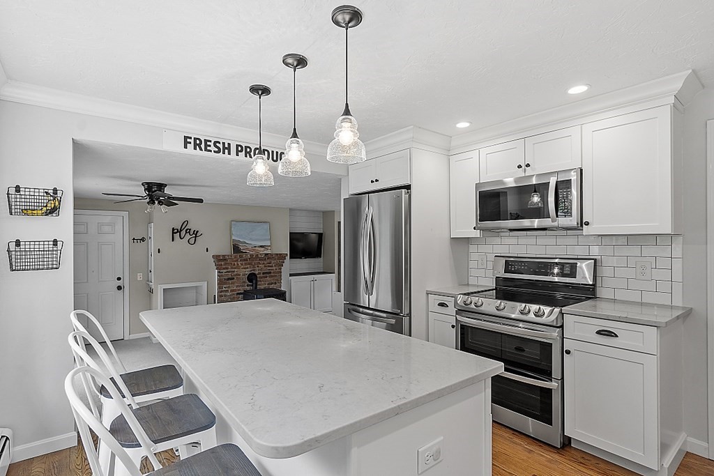 27 Tanglewood Road Sterling, MA 01564 - Photo 8 of 38 a kitchen with refrigerator cabinets and microwave
