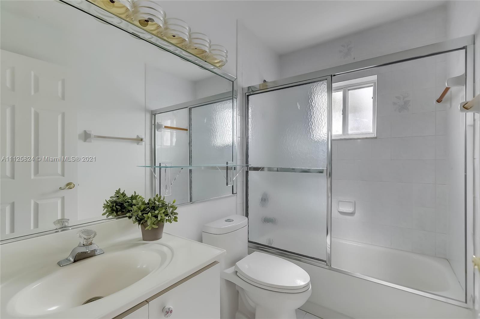 6858 West 30th Lane Hialeah, FL 33018 - Photo 12 of 37 a bathroom with a sink toilet and shower