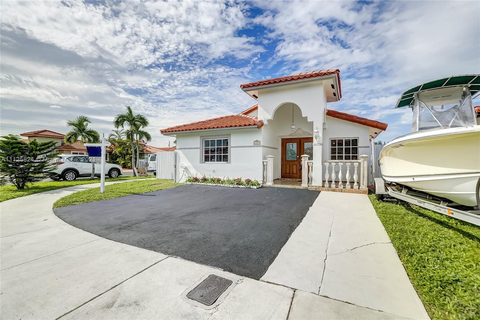 6858 West 30th Lane Hialeah, FL 33018 - Photo 3 of 37 a front view of a house with a yard and garage