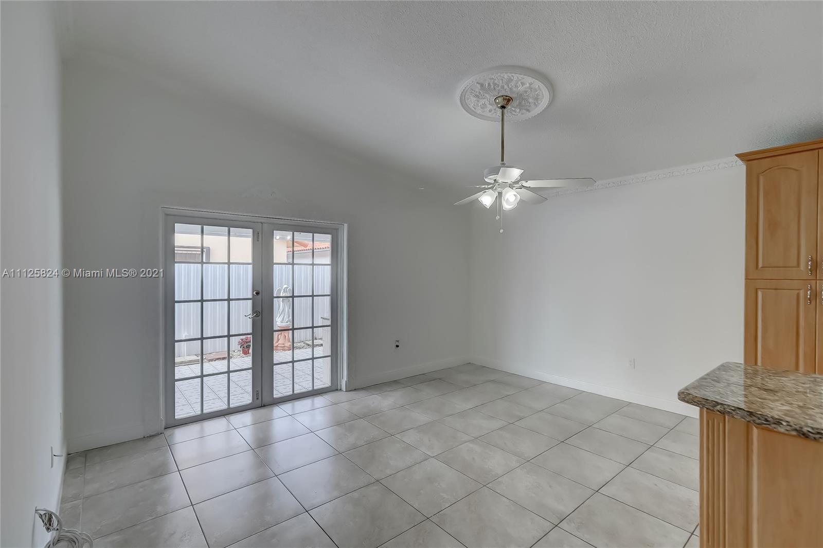 6858 West 30th Lane Hialeah, FL 33018 - Photo 21 of 37 a view of an empty room with a window