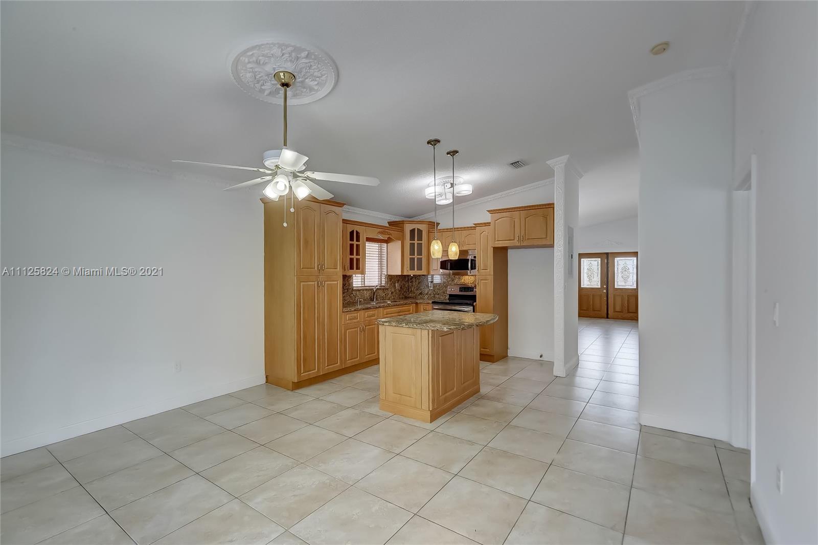 6858 West 30th Lane Hialeah, FL 33018 - Photo 23 of 37 a kitchen with a refrigerator a oven and a sink