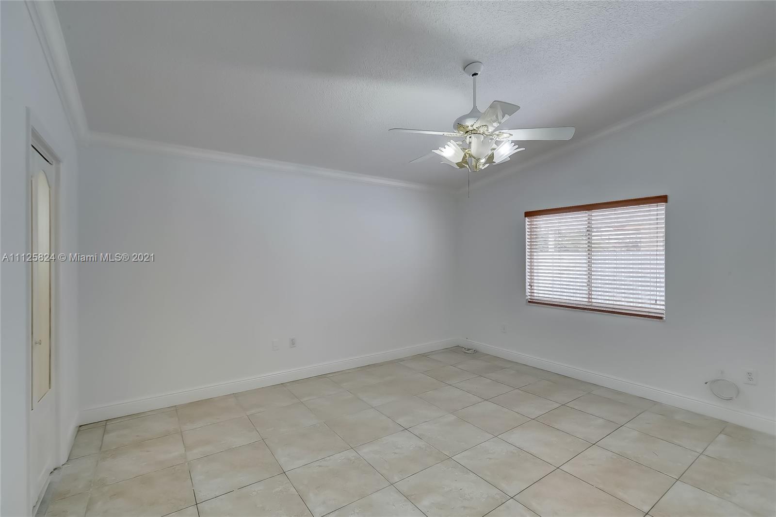 6858 West 30th Lane Hialeah, FL 33018 - Photo 24 of 37 a view of a chandelier fan in a room