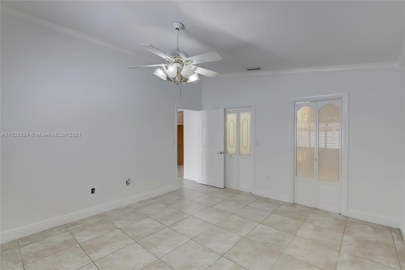 6858 West 30th Lane Hialeah, FL 33018 - Photo 26 of 37 an empty room with chandelier fan