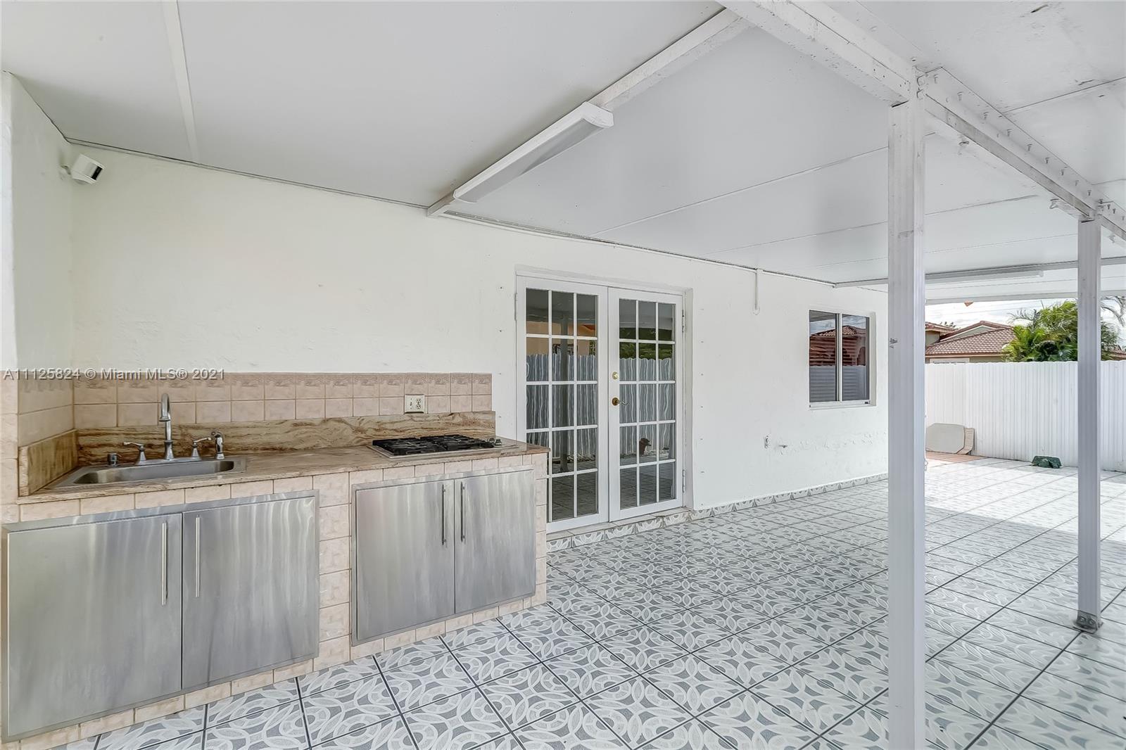 6858 West 30th Lane Hialeah, FL 33018 - Photo 32 of 37 a kitchen with stainless steel appliances granite countertop a stove and a cabinets