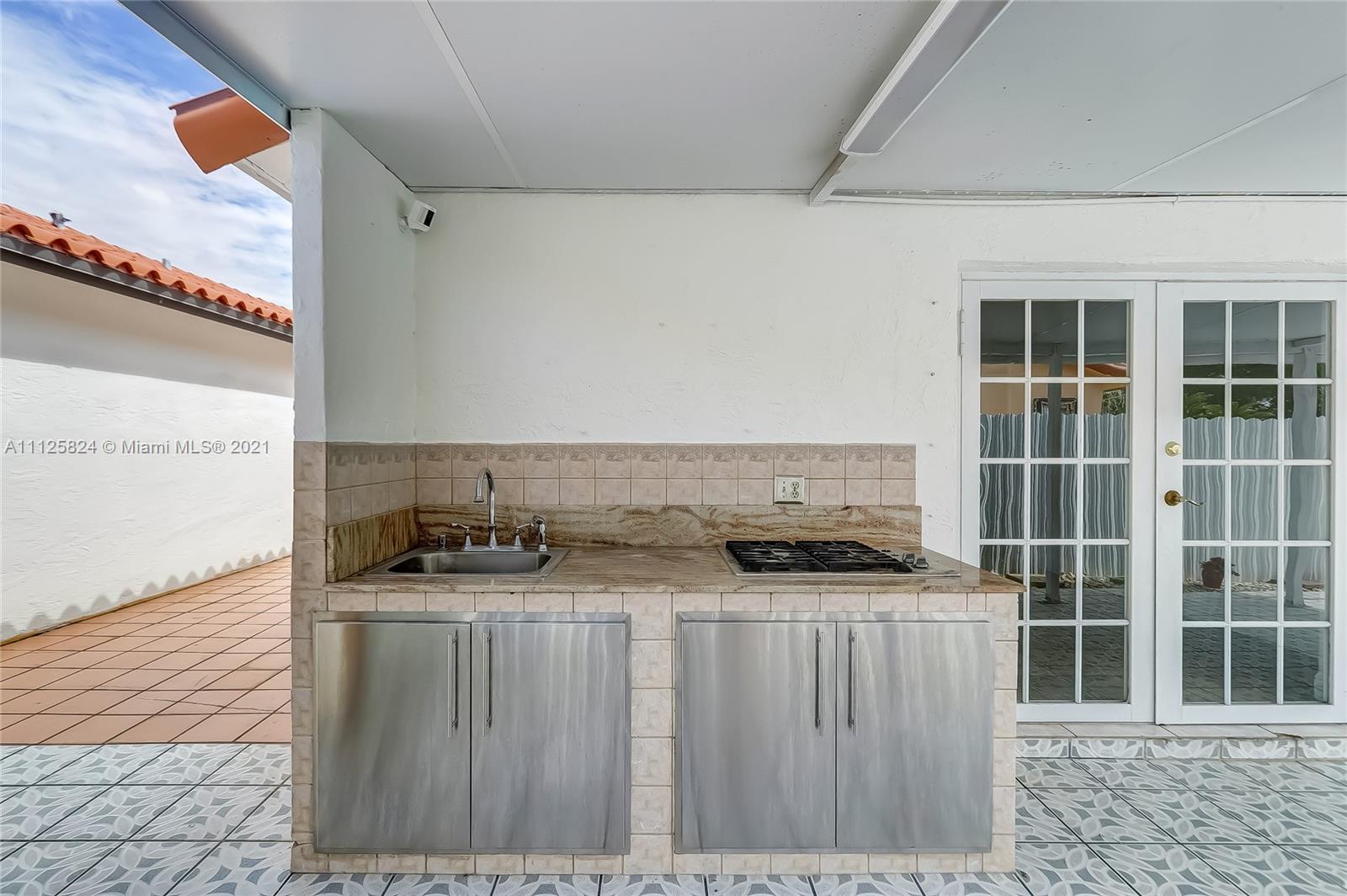 6858 West 30th Lane Hialeah, FL 33018 - Photo 33 of 37 a kitchen with granite countertop a sink and a stove