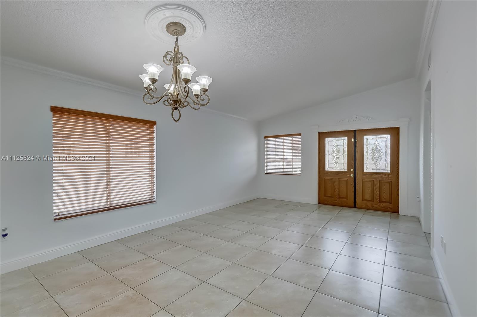 6858 West 30th Lane Hialeah, FL 33018 - Photo 8 of 37 a view of an empty room with a window